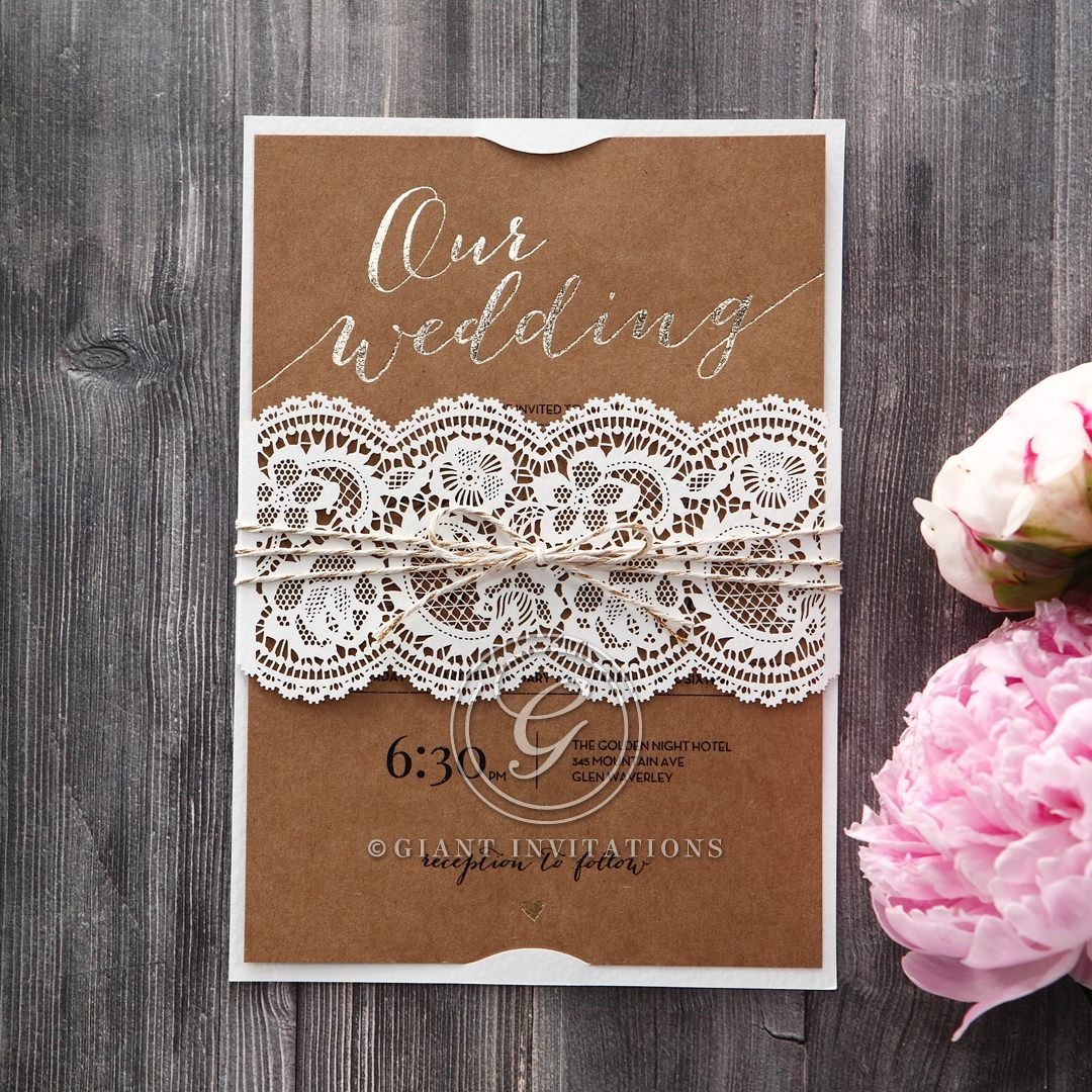 Rustic brown craft paper, gold foiled stamp in calligraphic letters enclosed in a matte white card with lace inspired sleeve wrapped with a twine
