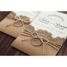 Lightly textured inner card printed in raised ink with intricate laser cut detailed pocket, secured with a twine