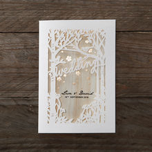 Wooden background on a forest theme invite with lasercut details, adorned with shimmering golden flowers
