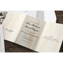 Black calligraphic fonts on a wooden theme trifold inner card with gold foiled flowers and white envelope