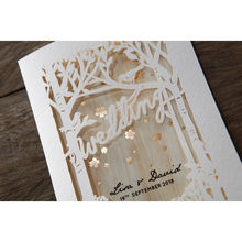 Forest theme lasercut cover with birds and trees on a white textured card, with wood theme inner card and golden flowers
