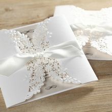 Ivory coloured insert card inside a matte white gatefold invite, secured by a knotted silky smooth lace 