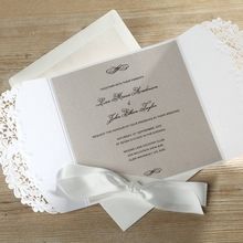 Light grey insert card printed in black raised calligraphic writing, white gatefold card and knotted lace with white envelope