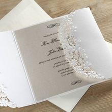 Floral lasercut sleeve on a white gatefold invite with pearlised insert card printed in black high rise fonts