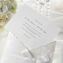 Floral silver design on a white pocket invite, wrapped with a silky smooth ribbon, and a white insert card
