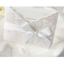 Embossed border on a smooth insert card, enclosed in a silk screened pocket invite with a dainty ribbon