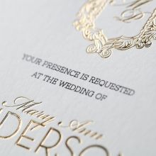Elegant engineered lettering printed in black high rise fonts, between the gold foiled elegant monogram and customisable names