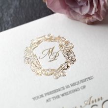 Shimmering hot gold foiled monogram with regal inspired surrounding frame with black raised ink printing