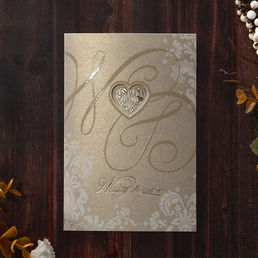 Trifold card in shimmering gold, preprinted in gold foil stamp, with a heart shaped die cut center
