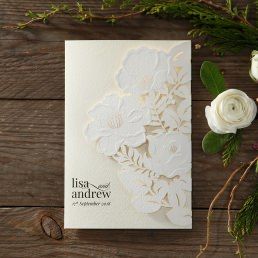 Lightly textured invite with a stunning embossed laser cut floral front cover, embellished with golden dots on front and back
