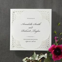 Dashing silk screened invite with clover shaped center framed by laser cut swirl shaped borders
