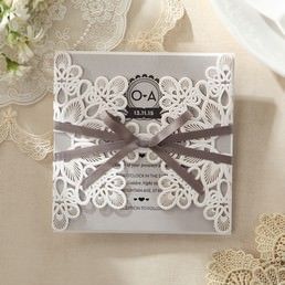 Intricate die cut card with embossed floral design wrapped with a deep brown satin ribbon enclosing a pearlised insert card in changeable colours
