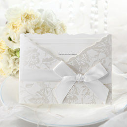 Embossed white inner card with raised ink printing, enclosed in a silk-screened pocket with silver floral decoration
