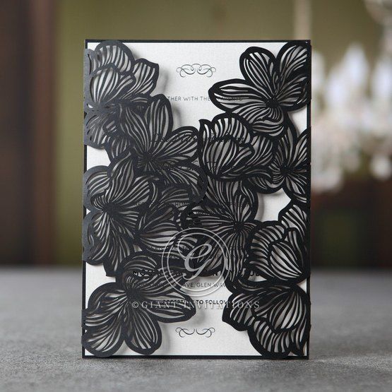 Black laser cut invitation, floral wrap, white inner paper